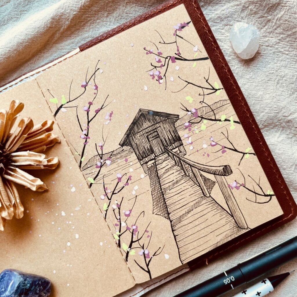 Ký hoạ ngôi nhà giữa hồ trên sổ kraft